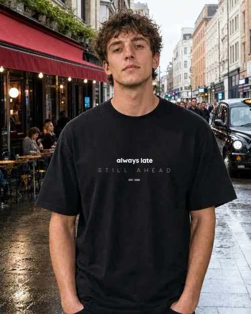 Always Late Still Ahead black oversized T-shirt, male model, front view, UK daytime