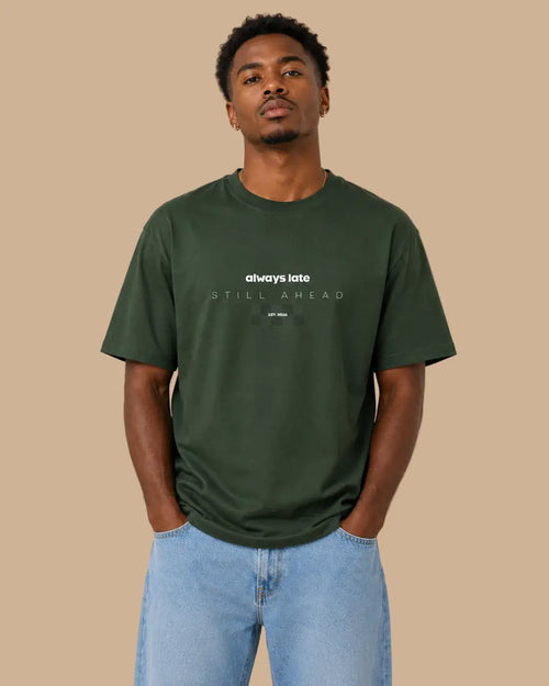 Front view of the Always Late Still Ahead forest green oversized Cabeça Dura T-shirt