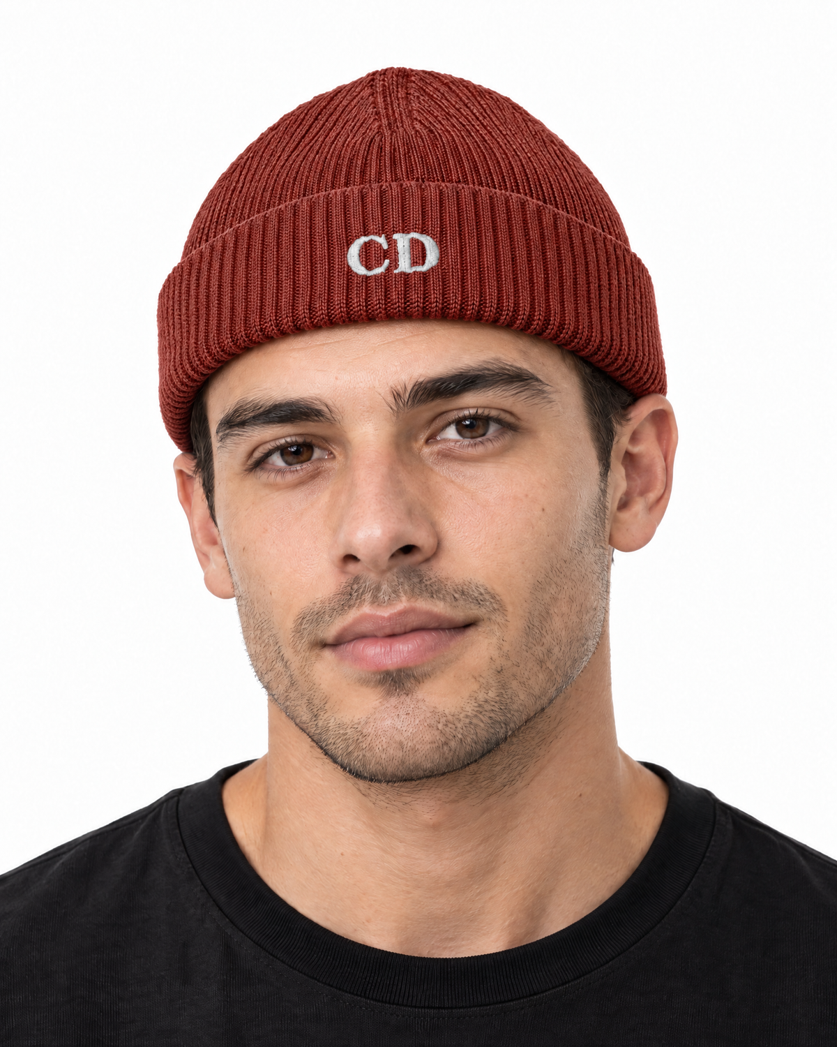 CD Fisherman Beanie — Earthy Red, worn front portrait on a white background with white CD embroidery.