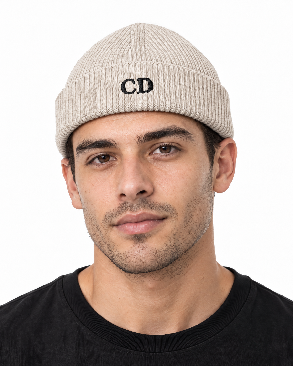 CD Fisherman Beanie — Natural, worn front portrait on a white background with black CD embroidery.