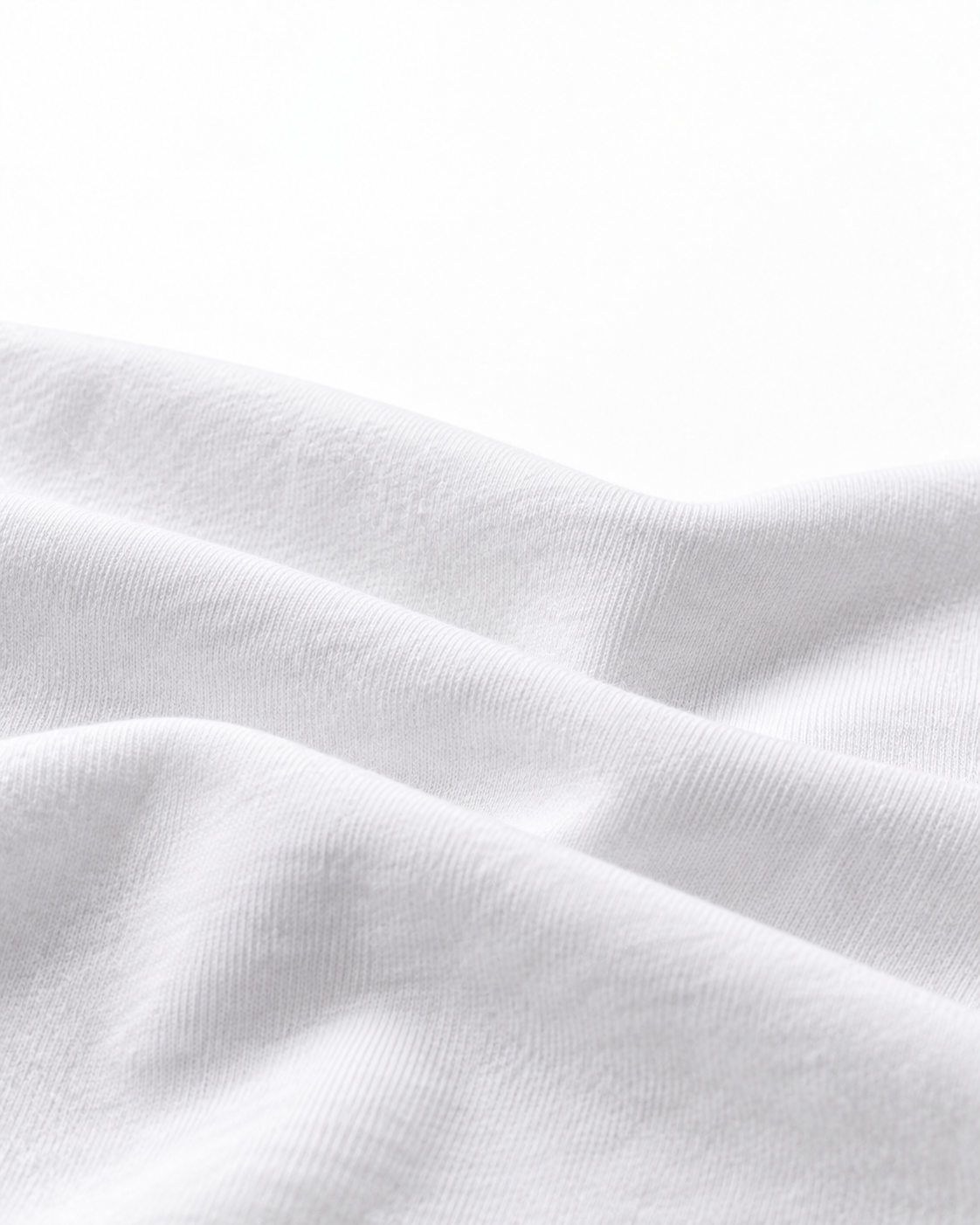 Editorial study of softly folded white cotton jersey