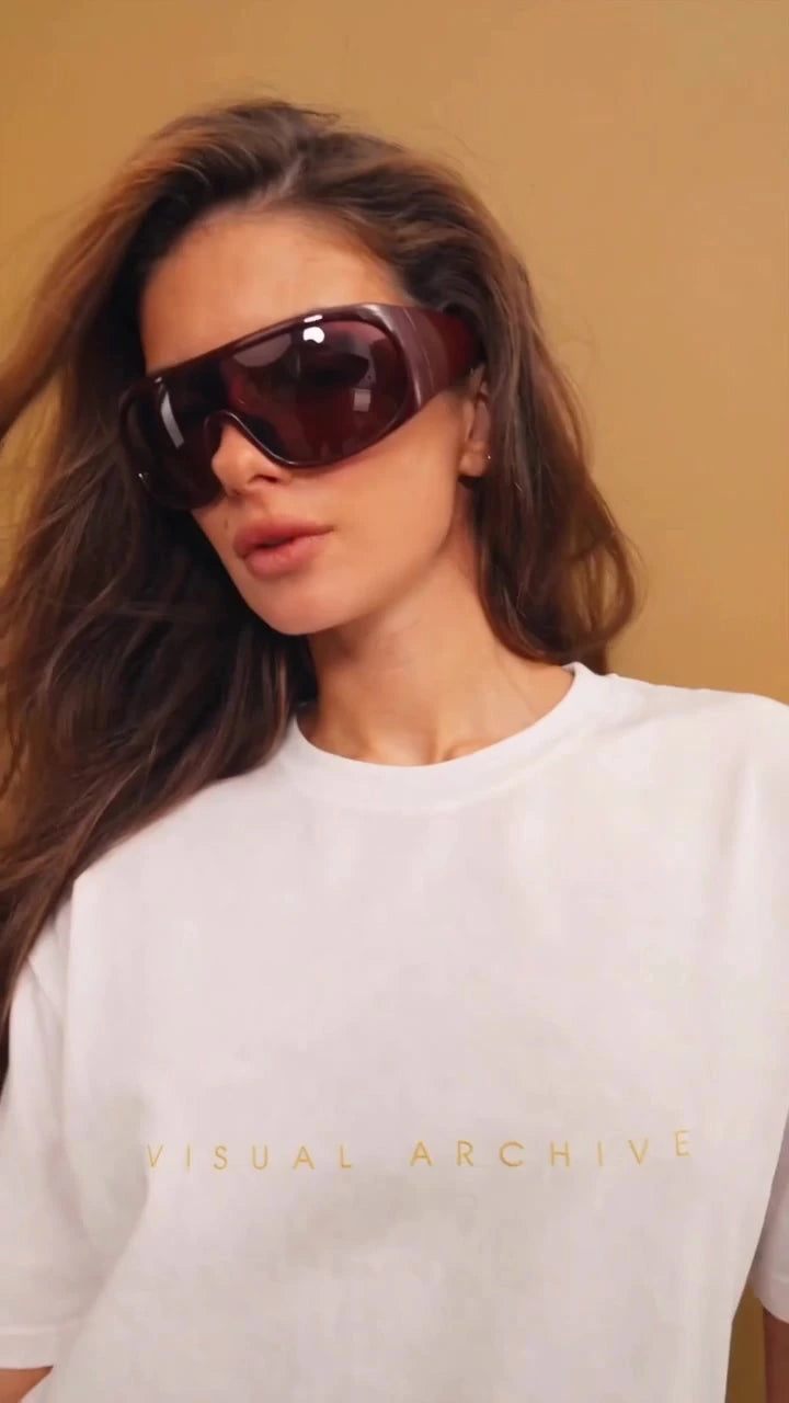 Close view of the gold Visual Archive lettering on a white Augusta T-shirt